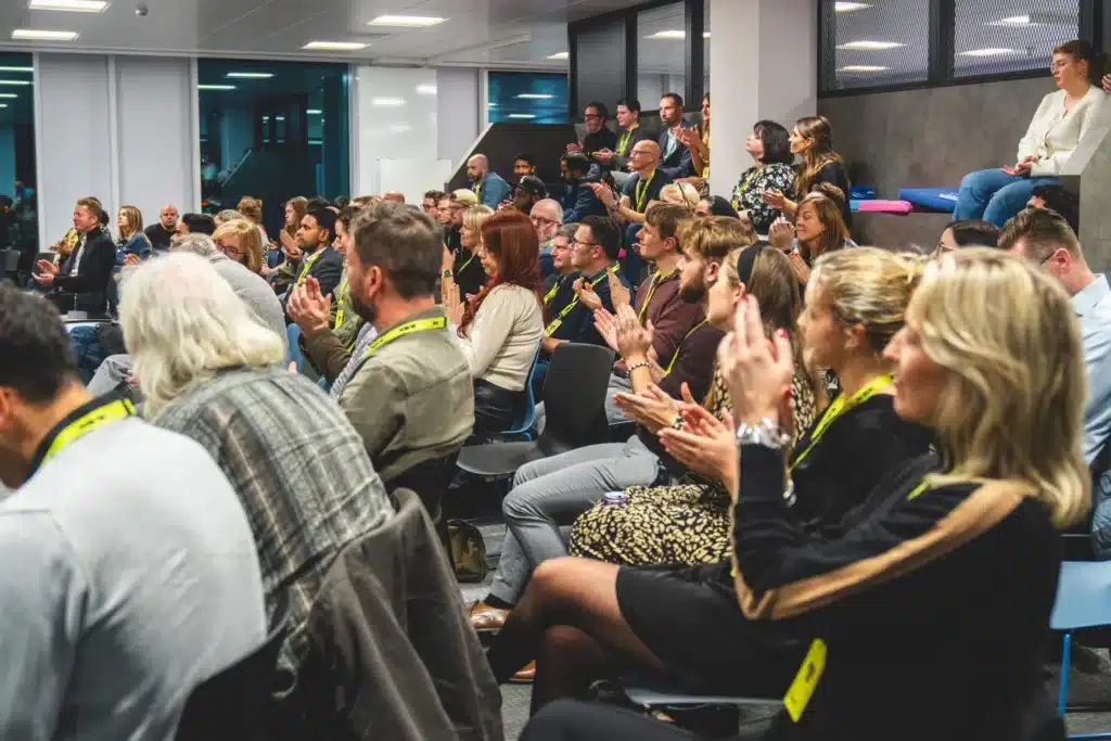 An audience applauding during a talk